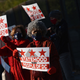 Activists hold signs as they take part in a rally in support of DC statehood near the US Capitol in Washington, DC on March 22, 2021.